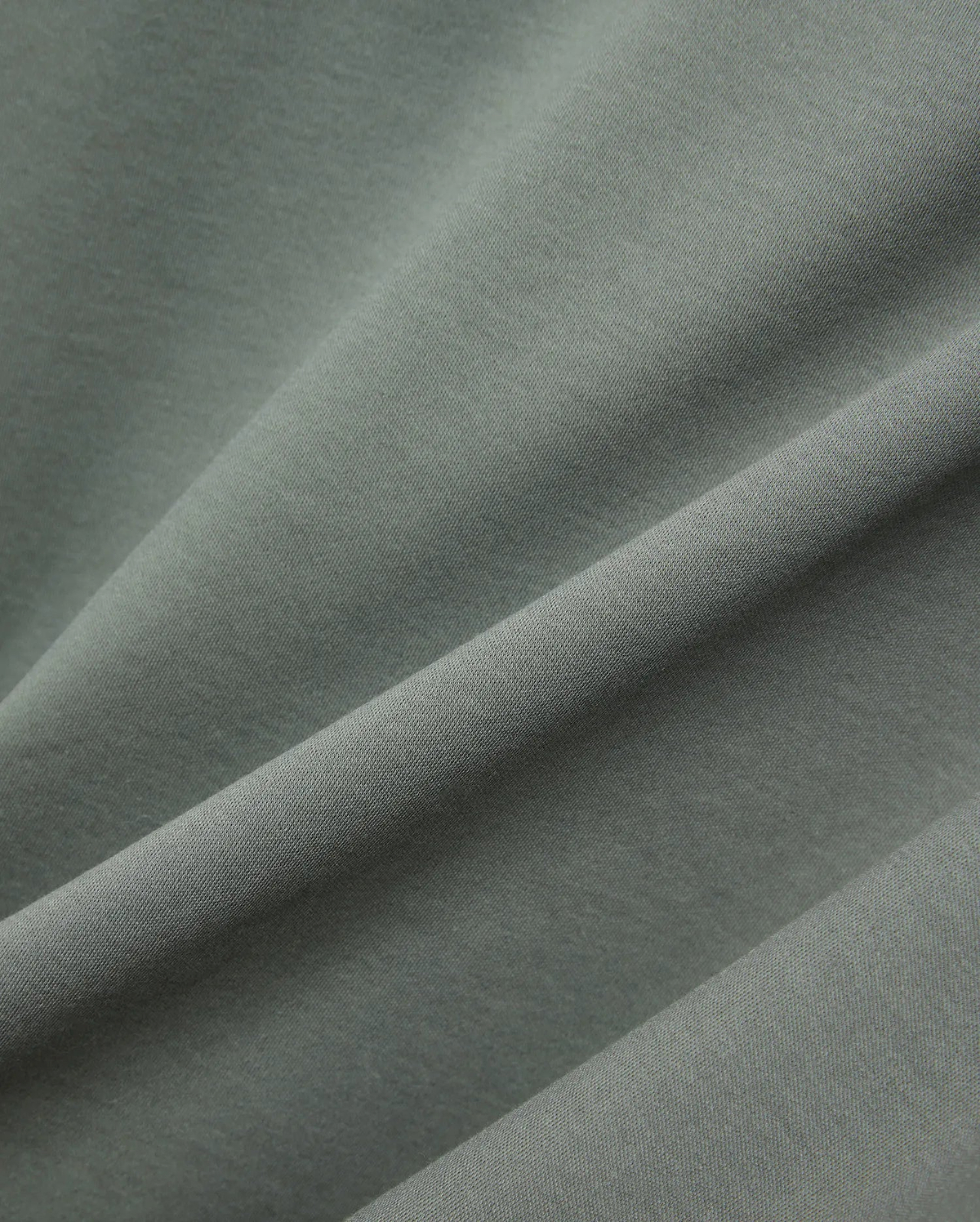 MENS OSCAR OVERSIZED TEE, a premium oversized tee in a rich sage green, featuring a finely textured, soft jersey knit fabric with elegant drapes and subtle sheen. (5)