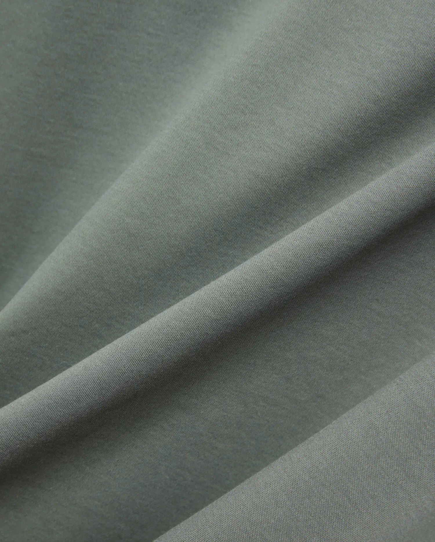 MENS OSCAR OVERSIZED TEE, a premium oversized tee in a rich sage green, featuring a finely textured, soft jersey knit fabric with elegant drapes and subtle sheen. (5)