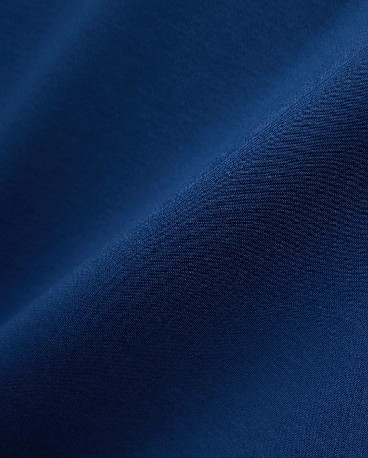 Premium deep blue Mens Oscar Relaxed Fit Tee, crafted from soft jersey knit fabric, featuring the iconic embroidered Psycho Bunny skull logo on the left chest.