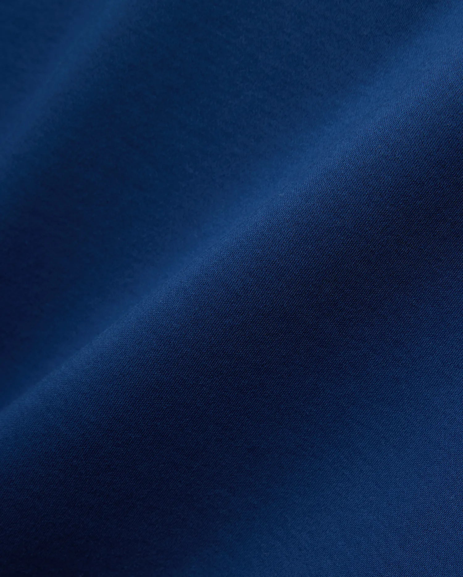 Premium deep blue Mens Oscar Relaxed Fit Tee, crafted from soft jersey knit fabric, featuring the iconic embroidered Psycho Bunny skull logo on the left chest.