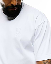 Mens Oscar Relaxed Fit Tee in white, featuring a relaxed fit and smooth jersey fabric. A small, tone-on-tone embroidered Psycho Bunny skull logo is on the left chest.