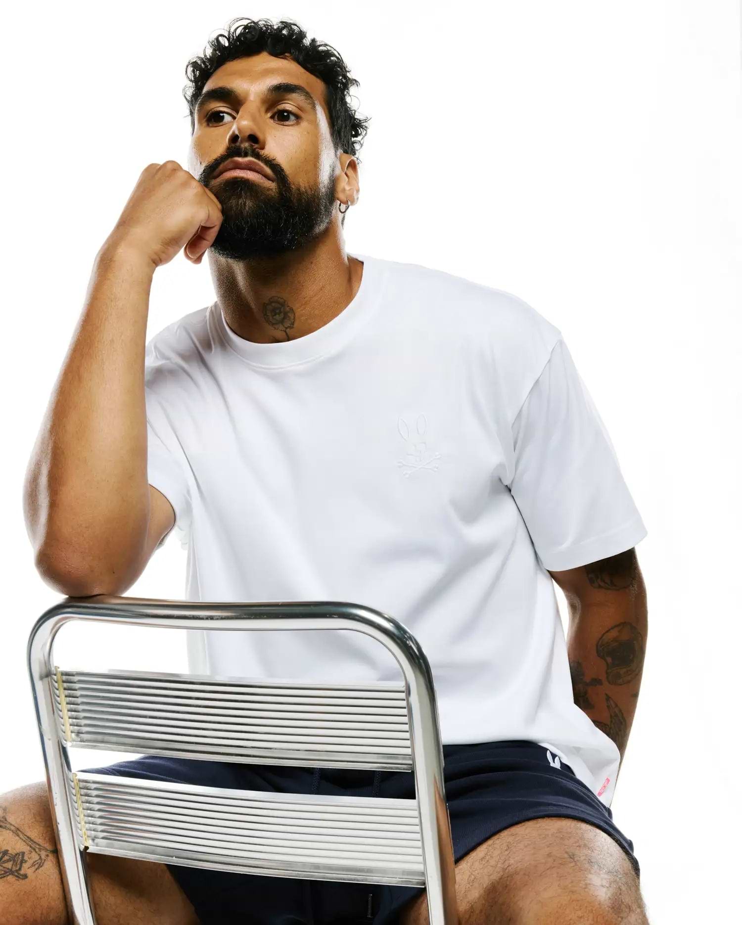 White MENS OSCAR RELAXED FIT TEE in smooth jersey knit, featuring a small, tone-on-tone embroidered Psycho Bunny skull logo on the left chest.