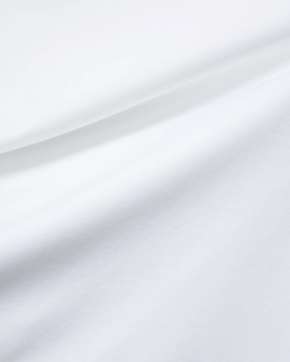 Mens Oscar Relaxed Fit Tee in premium, soft white jersey fabric, featuring subtle fabric folds and the signature small embroidered Psycho Bunny skull logo on the chest.