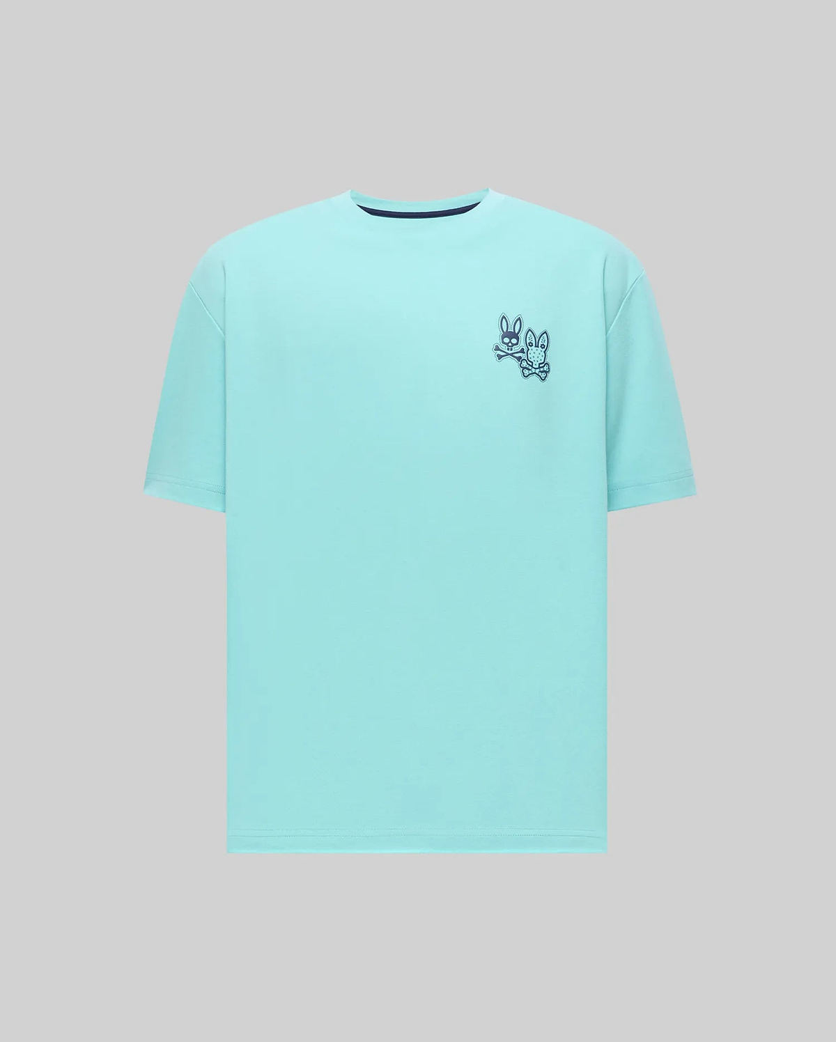 Mens Luke Back Graphic Tee, a relaxed fit aqua t-shirt in smooth jersey knit, featuring small embroidered dark blue Psycho Bunny skull logos with crossbones on the left chest.