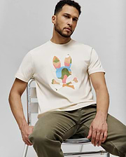 Mens Ara Graphic Tee, a classic fit cream jersey t-shirt featuring a large, multi-colored abstract Psycho Bunny skull logo graphic on the chest.