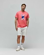 Mens Ara Graphic Tee in coral, featuring a classic fit jersey knit with a large, vibrant abstract blue and pink Psycho Bunny skull graphic on the center chest.