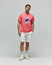 Mens Ara Graphic Tee in coral, featuring a classic fit jersey knit with a large, vibrant abstract blue and pink Psycho Bunny skull graphic on the center chest.
