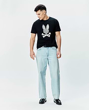 Mens Brad Graphic Tee, black classic fit jersey t-shirt featuring a large white paisley-filled Psycho Bunny skull logo on the chest.
