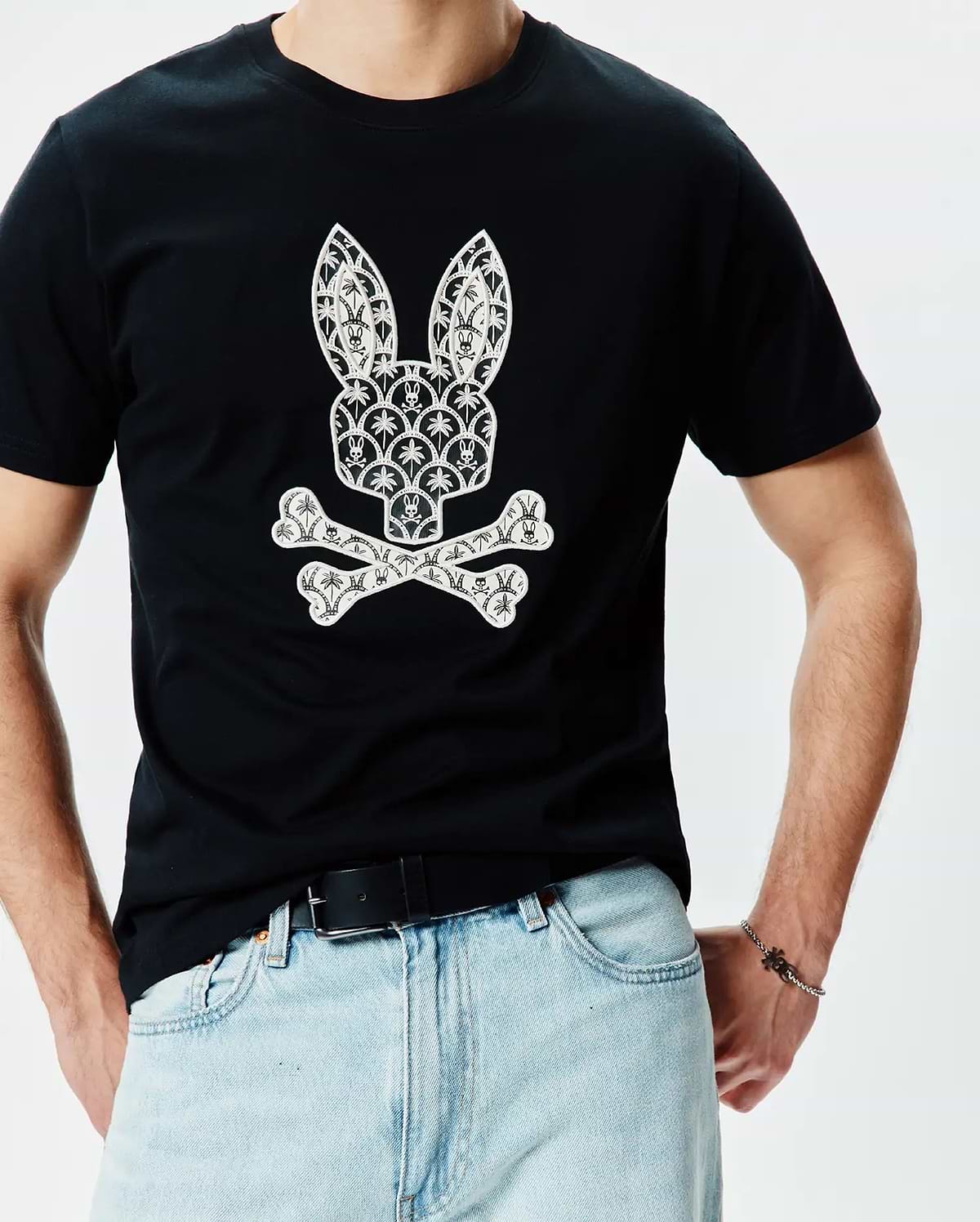 Mens Brad Graphic Tee, black classic fit smooth jersey t-shirt with a large white central Psycho Bunny skull and crossbones logo graphic, detailed with small bunny skulls and palm trees.