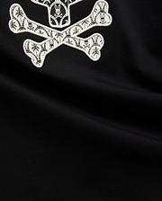 Mens Brad Graphic Tee, black smooth jersey with a large white embroidered Psycho Bunny skull and crossbones graphic, featuring tropical palm trees and mini bunny skulls within the bones.