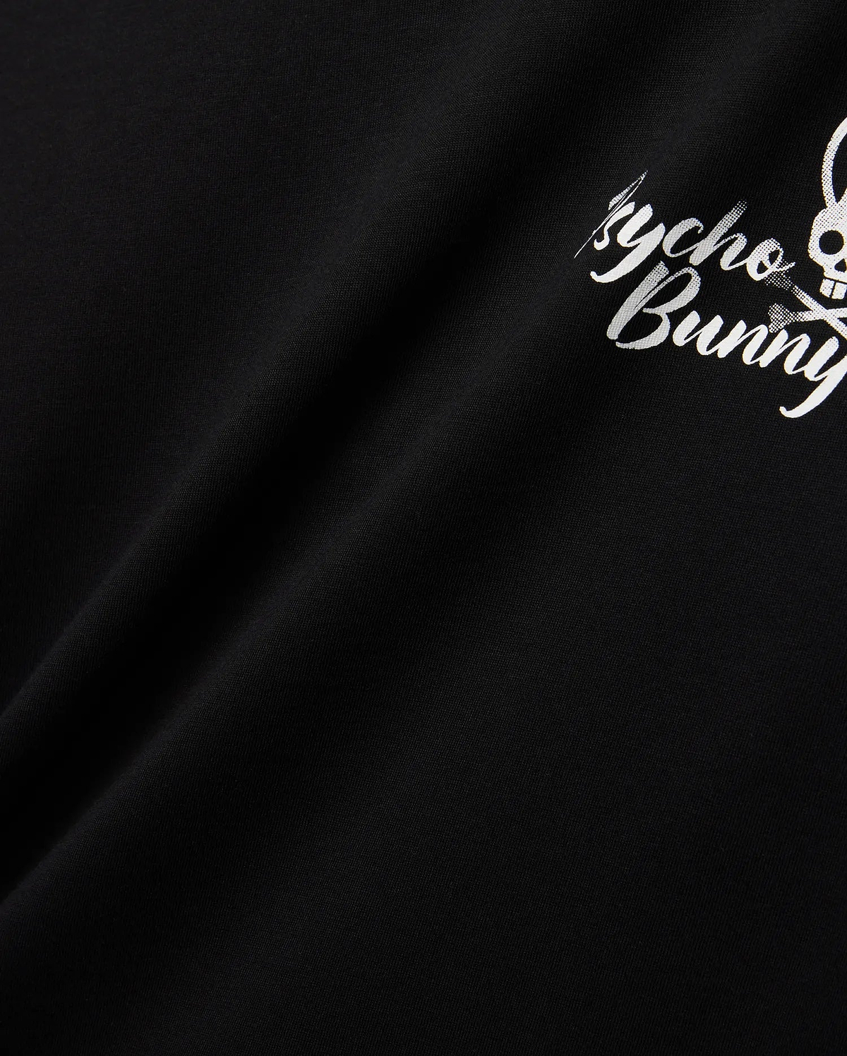 Mens Colin Back Graphic Tee in black, crafted from smooth jersey knit, showcasing a bold white Psycho Bunny script and iconic bunny skull logo graphic on the back.