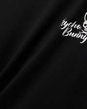 Mens Colin Back Graphic Tee in black, crafted from smooth jersey knit, showcasing a bold white Psycho Bunny script and iconic bunny skull logo graphic on the back.