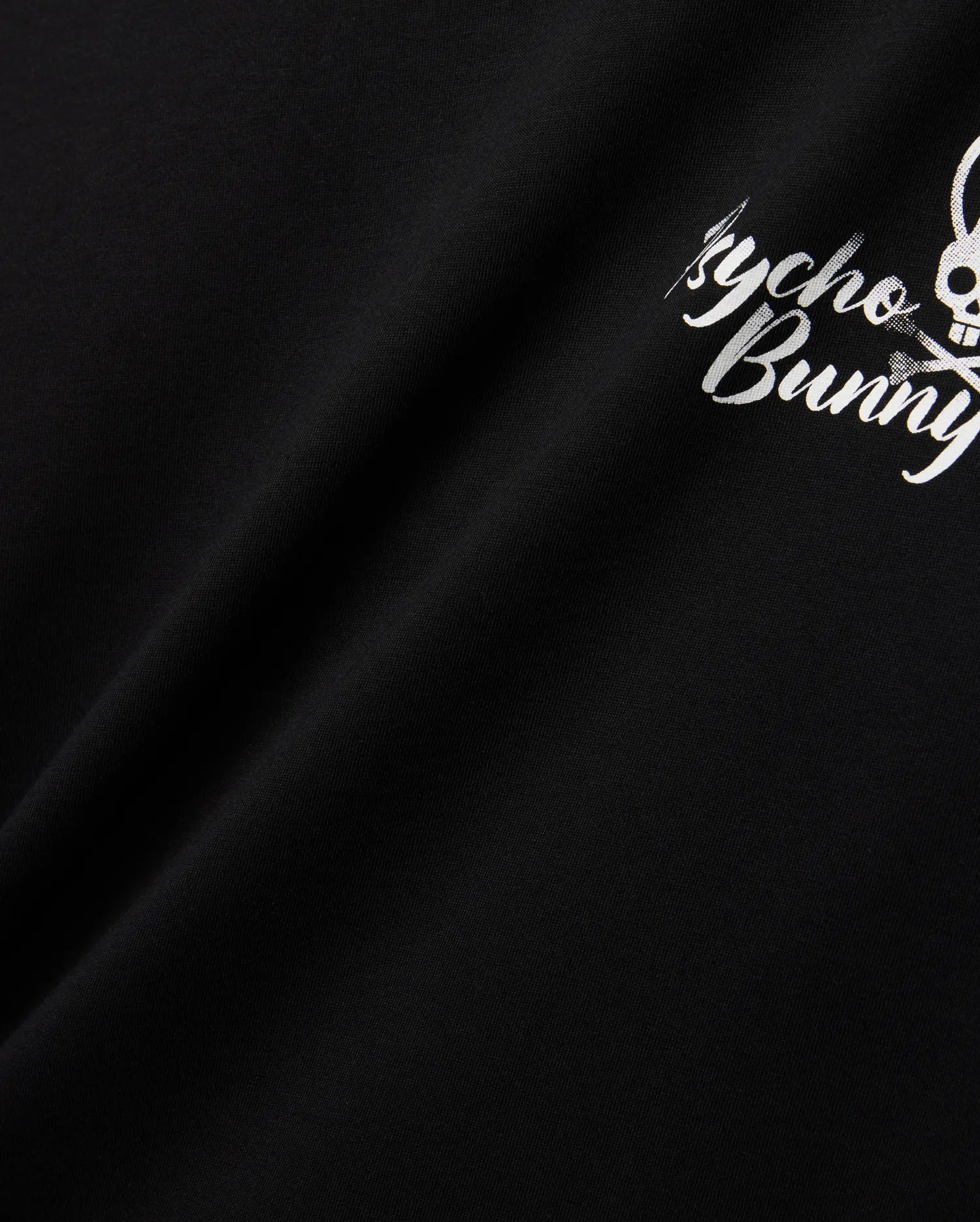 Mens Colin Back Graphic Tee in black, crafted from smooth jersey knit, showcasing a bold white Psycho Bunny script and iconic bunny skull logo graphic on the back.