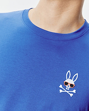 Royal blue classic fit jersey knit T-shirt featuring a small, embroidered Psycho Bunny skull logo with orange sunglasses and white crossbones on the left chest. Mens Sunny Chest Graphic Tee.