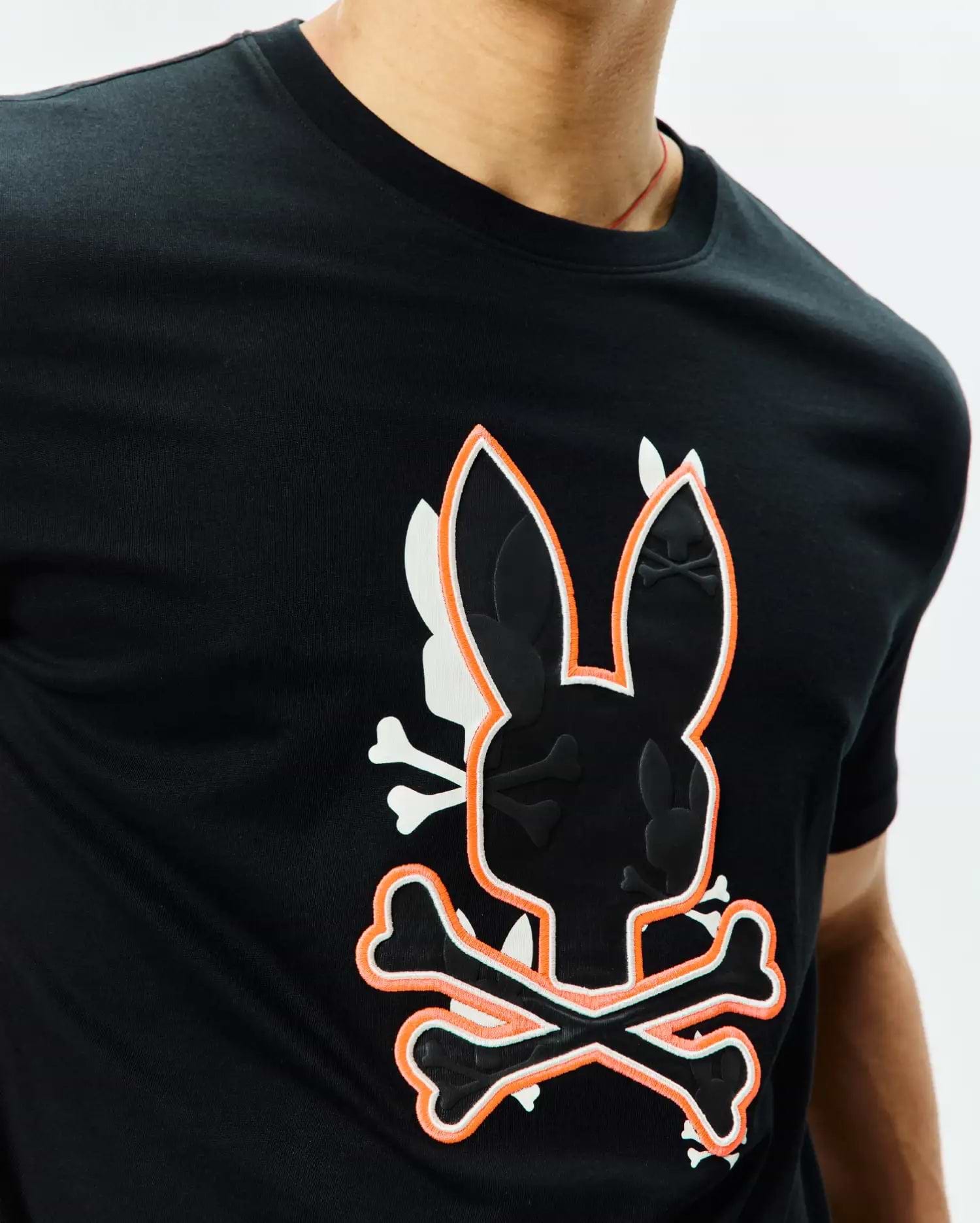 Mens Tanner Bunny Graphic Tee, a black jersey knit t-shirt with a large central orange and white outlined bunny skull and crossbones graphic featuring embossed mini bunny skulls.