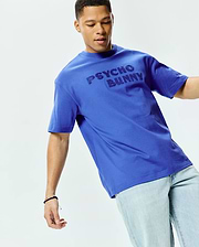 Mens Craig Wordmark Tee, a vibrant royal blue relaxed fit jersey t-shirt featuring a large, tonal embossed PSYCHO BUNNY wordmark across the chest.