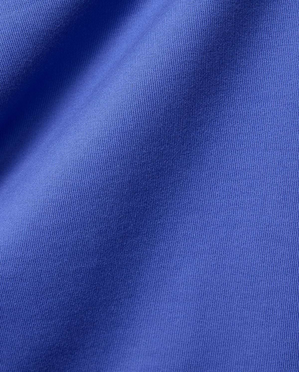 Mens Craig Wordmark Tee crafted from a premium, vibrant blue jersey knit fabric, showcasing a smooth texture with subtle vertical ribbing and elegant, soft folds.