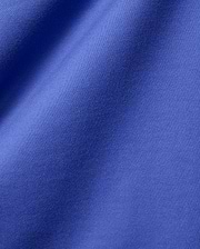 Mens Craig Wordmark Tee crafted from a premium, vibrant blue jersey knit fabric, showcasing a smooth texture with subtle vertical ribbing and elegant, soft folds.