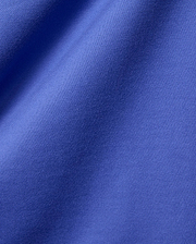 Mens Craig Wordmark Tee crafted from a premium, vibrant blue jersey knit fabric, showcasing a smooth texture with subtle vertical ribbing and elegant, soft folds.