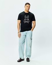 Mens Craig Graphic Tee, a classic fit black cotton jersey t-shirt featuring a large white outline Psycho Bunny skull and crossbones graphic logo centered on the chest.