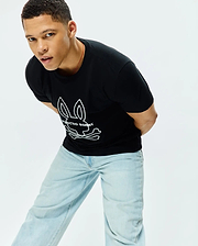 Mens Craig Graphic Tee, a classic fit black jersey t-shirt featuring a large white outline Psycho Bunny skull and crossbones logo with text centrally placed on the chest.