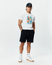 White Mens Tanner Graphic Tee, classic fit, soft jersey, featuring a large multi-color Psycho Bunny skull logo print. Complemented by black French terry shorts, a black cap with an embroidered white bunny logo, and white logo socks.
