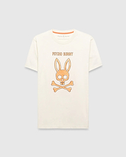 Cream Mens Adler Graphic Tee, classic fit jersey knit, featuring a large central orange Psycho Bunny skull and crossbones graphic with Psycho Bunny text above, and orange neck tape.