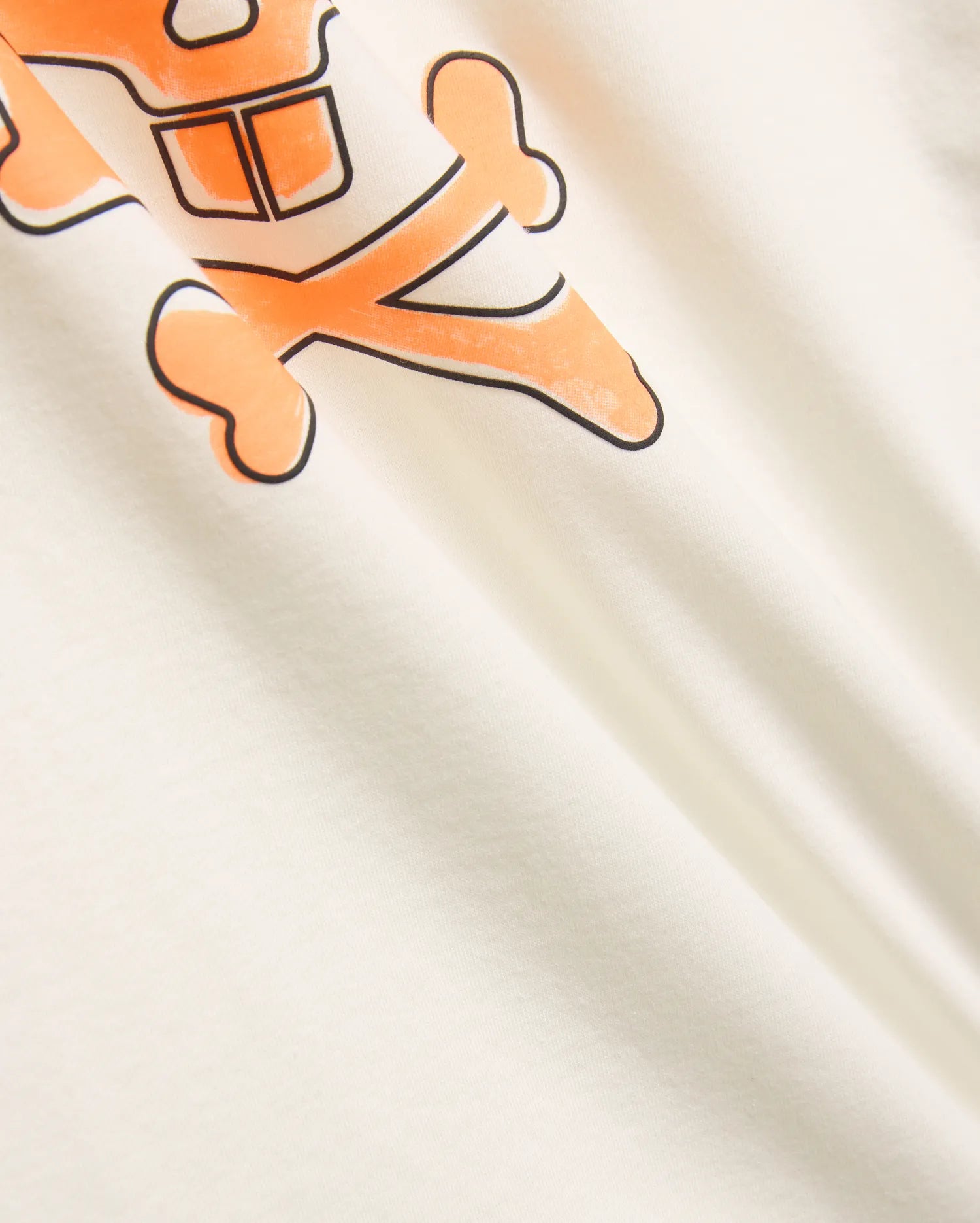 Mens Adler Graphic Tee, a cream smooth jersey t-shirt with a prominent, bold orange Psycho Bunny skull graphic outlined in black, showcasing iconic refined streetwear style.
