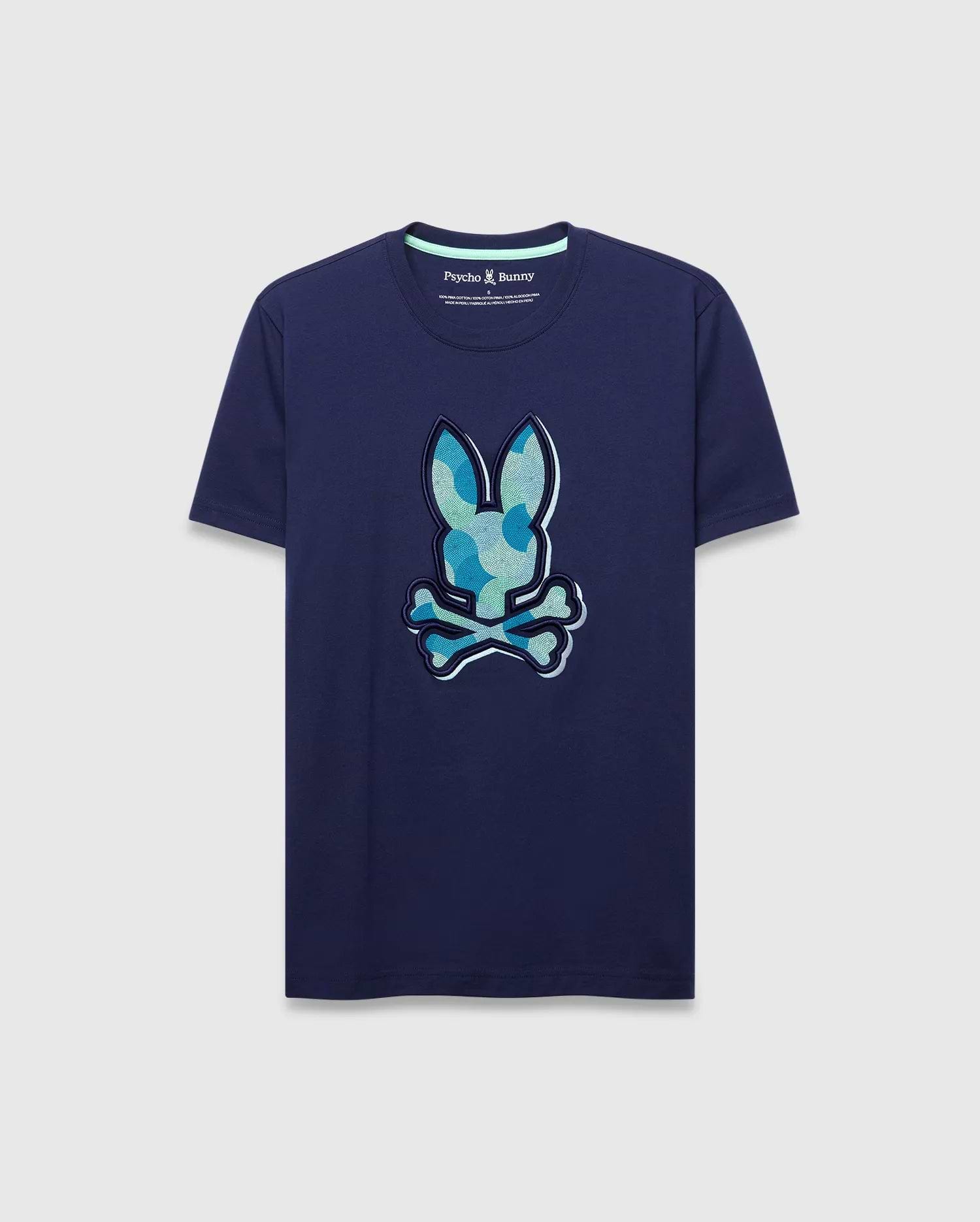 Mens Ethan Graphic Tee. Navy blue classic fit jersey t-shirt with a large center chest Psycho Bunny skull logo featuring a blue and green camouflage pattern and light blue outline. (1)
