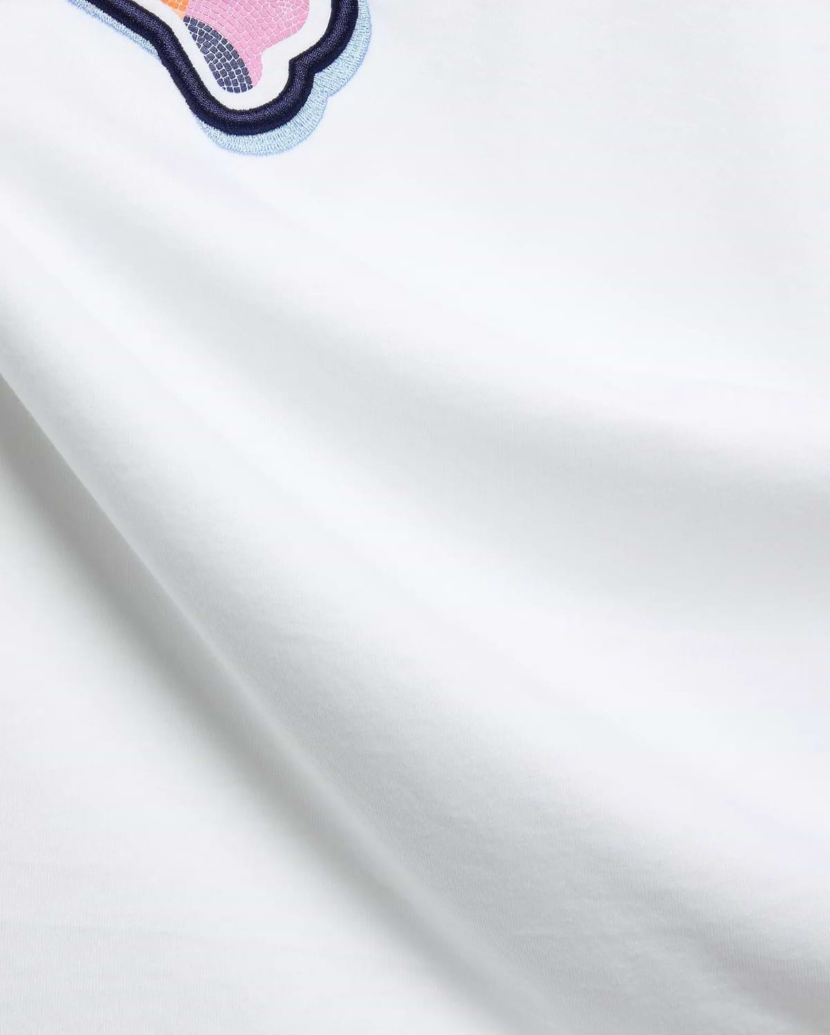 Mens Ethan Graphic Tee, a white soft jersey t-shirt featuring a prominent embroidered Psycho Bunny skull logo on the upper chest, detailed with vibrant pink, orange, and blue mosaic textures. (6)