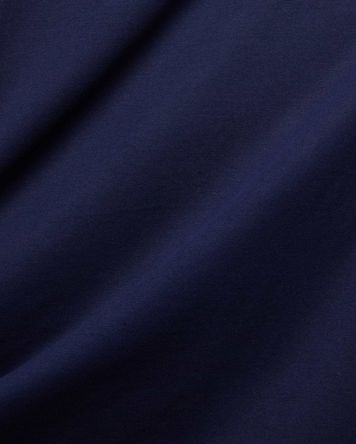 Rich, premium dark blue jersey fabric, subtly textured with soft folds, embodying the refined streetwear aesthetic of the Mens Frank Back Graphic Tee by Psycho Bunny.