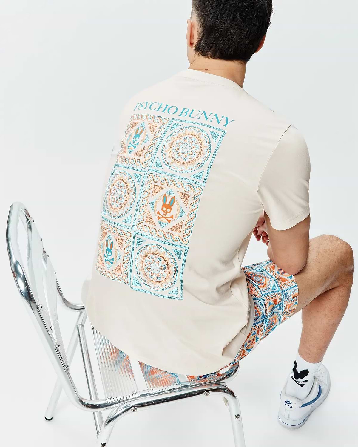 Cream Mens Frank Back Graphic Tee, classic fit jersey, with a large teal and orange geometric and Psycho Bunny skull back graphic, paired with matching relaxed fit woven shorts. (4)