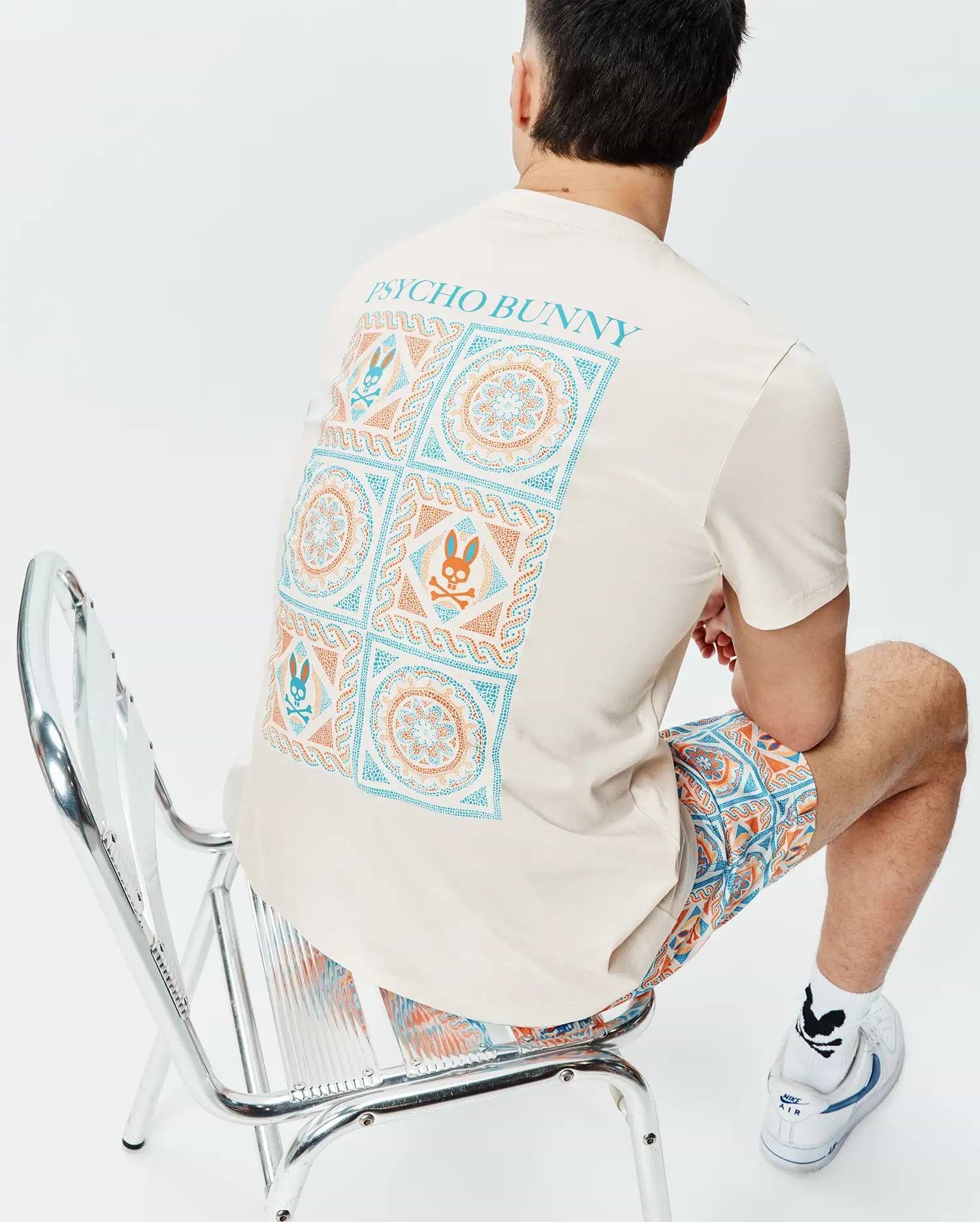 Cream Mens Frank Back Graphic Tee, classic fit jersey, with a large teal and orange geometric and Psycho Bunny skull back graphic, paired with matching relaxed fit woven shorts. (4)