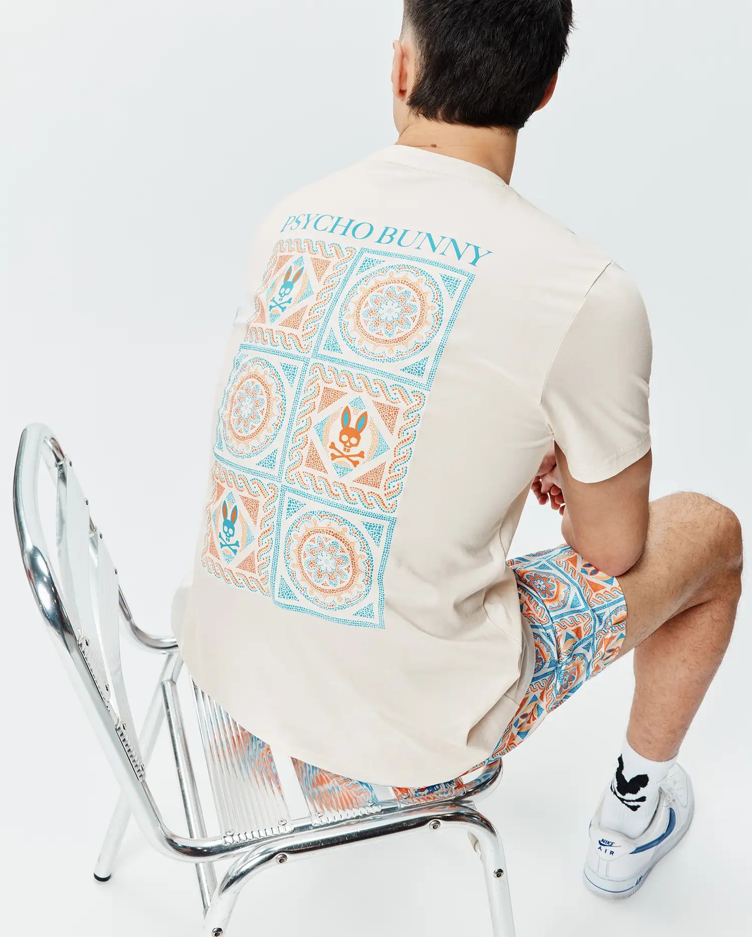 Cream Mens Frank Back Graphic Tee, classic fit jersey, with a large teal and orange geometric and Psycho Bunny skull back graphic, paired with matching relaxed fit woven shorts. (4)