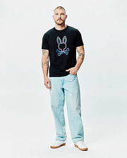 Mens Dayton Graphic Tee, a black classic fit jersey t-shirt featuring a large center chest graphic of the iconic Psycho Bunny skull and crossbones logo with a vibrant neon pink and blue outline. (4)
