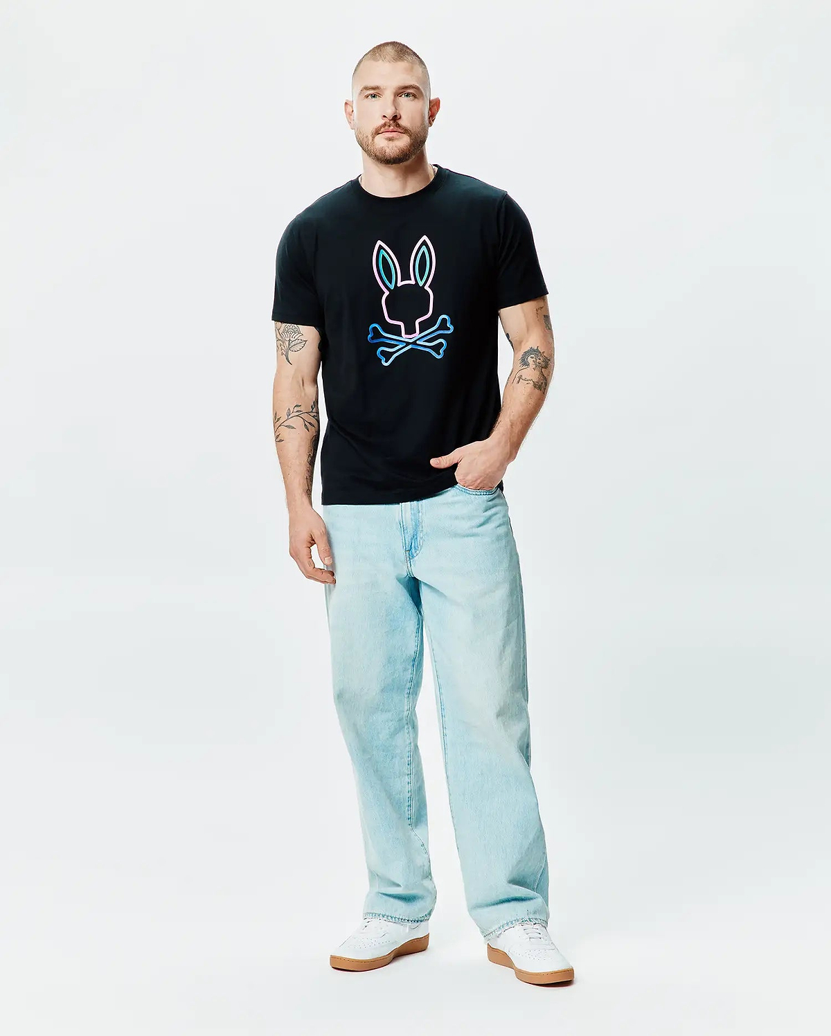 Mens Dayton Graphic Tee, a black classic fit jersey t-shirt featuring a large center chest graphic of the iconic Psycho Bunny skull and crossbones logo with a vibrant neon pink and blue outline. (4)