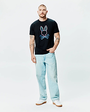 Mens Dayton Graphic Tee, a black classic fit jersey t-shirt featuring a large center chest graphic of the iconic Psycho Bunny skull and crossbones logo with a vibrant neon pink and blue outline. (4)