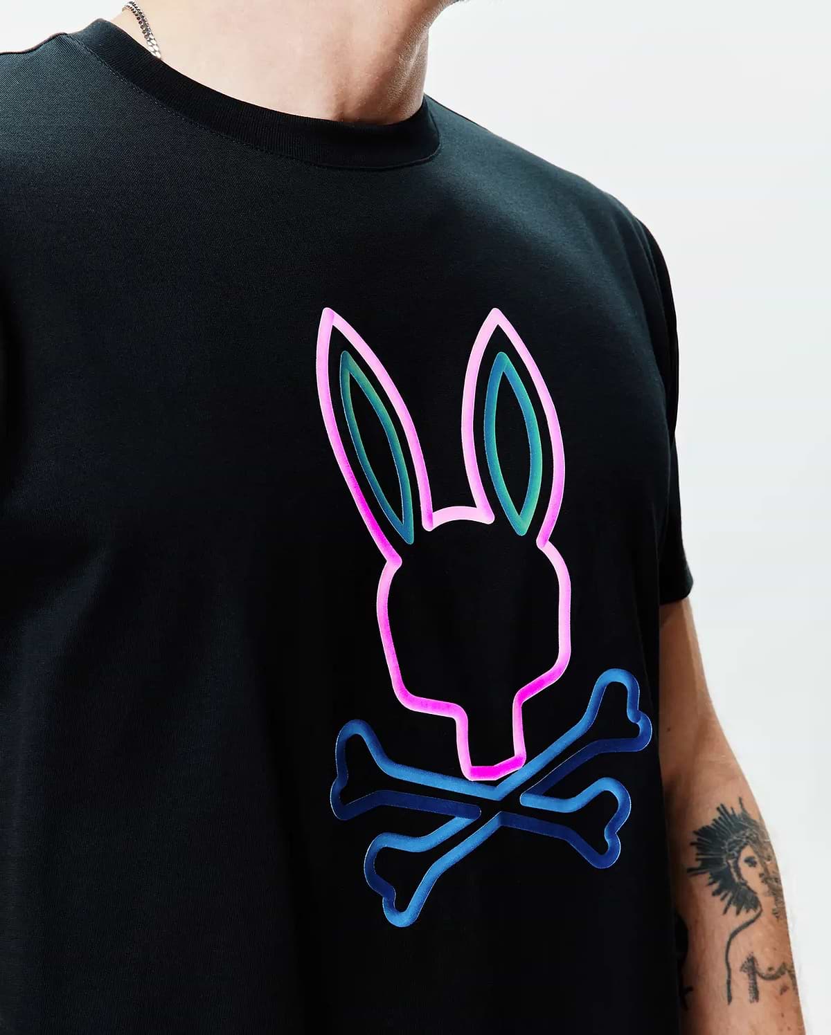 Black Mens Dayton Graphic Tee, a classic fit jersey knit featuring a large, central neon pink, teal, and blue outline Psycho Bunny skull graphic. (2)