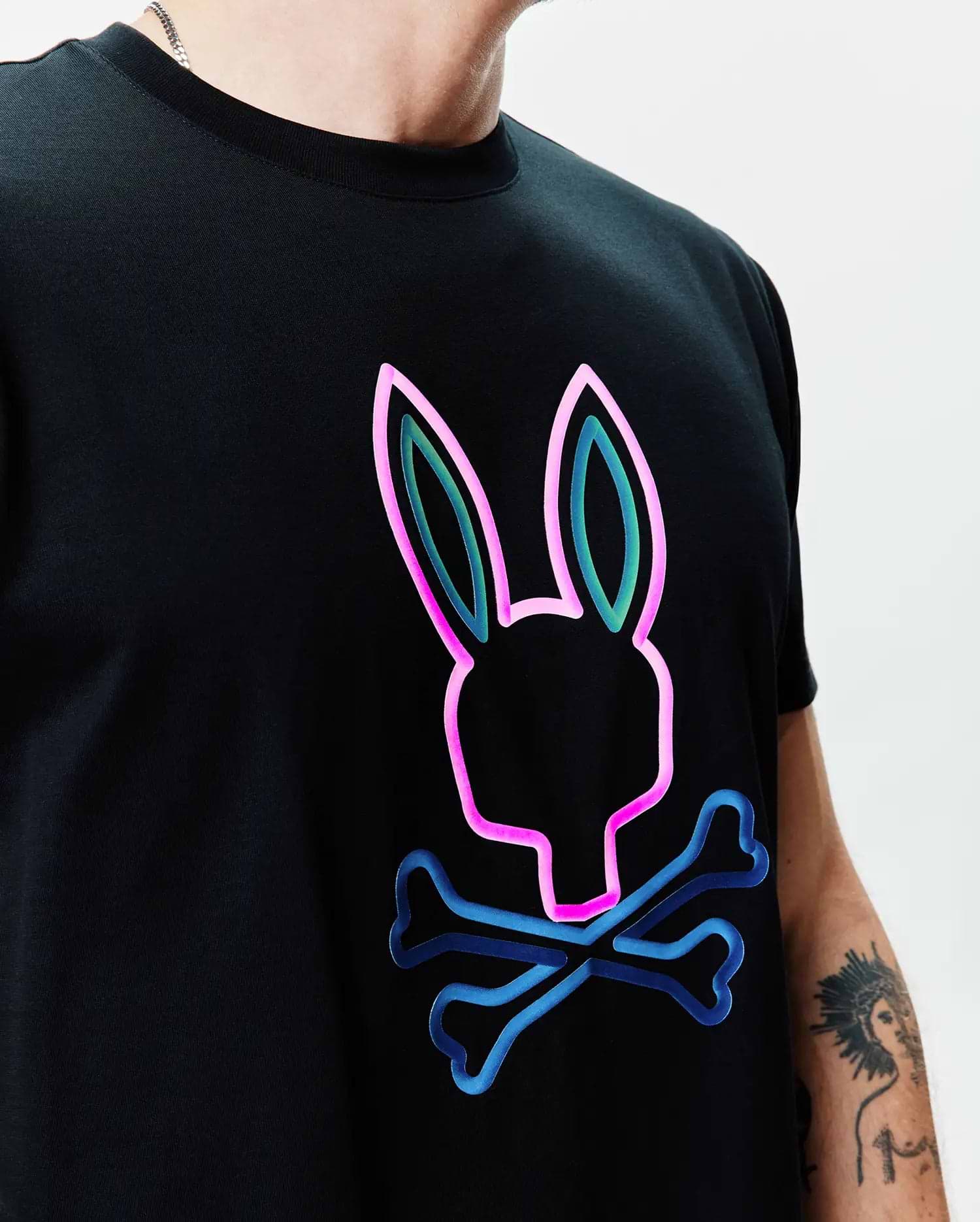 Black Mens Dayton Graphic Tee, a classic fit jersey knit featuring a large, central neon pink, teal, and blue outline Psycho Bunny skull graphic. (2)
