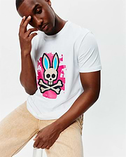 White Mens Marcus Bunny Graphic Tee, a classic fit jersey t-shirt featuring a large central Psycho Bunny skull and crossbones logo with blue ears over a vibrant pink brushstroke graphic.