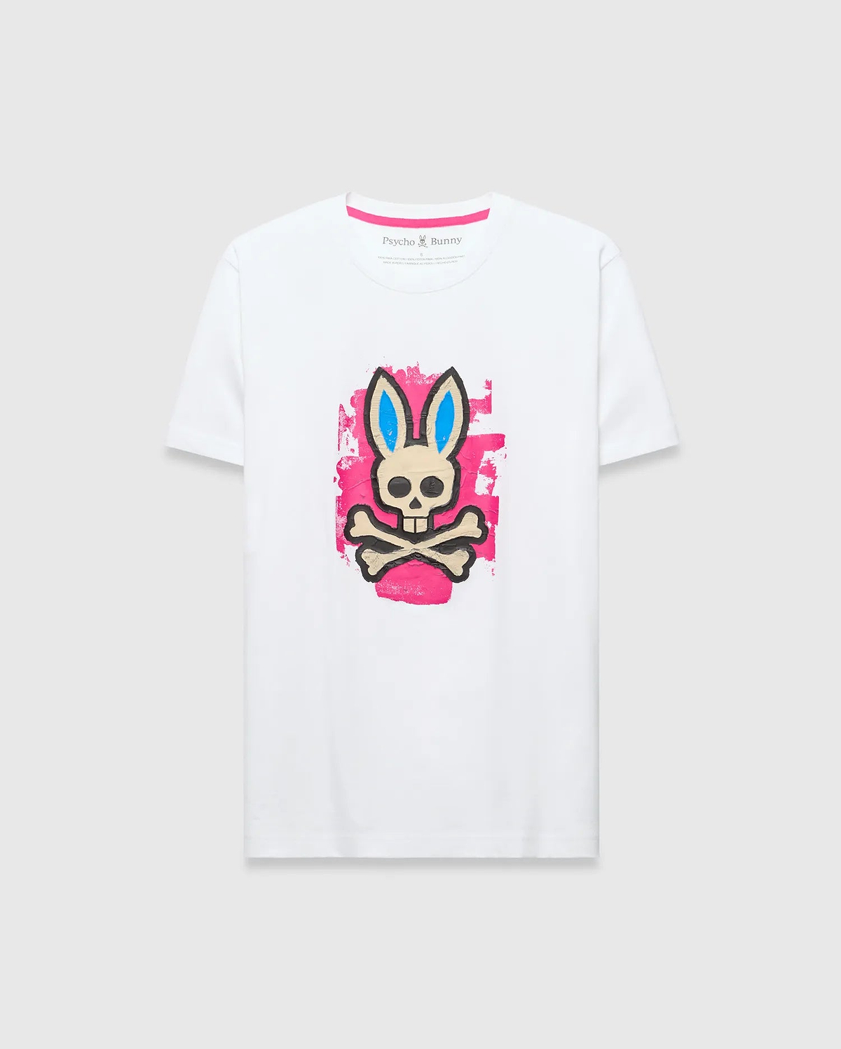 Mens Marcus Bunny Graphic Tee, white classic fit jersey t-shirt with a large distressed pink, blue, black, and beige Psycho Bunny skull graphic on the chest and pink neck tape.