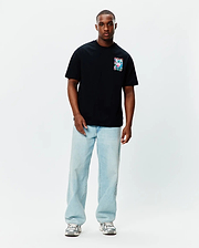 Black Mens Isaac Relaxed Fit Tee, a soft jersey t-shirt featuring a small, square, vibrant multi-color Psycho Bunny skull graphic on the left chest.