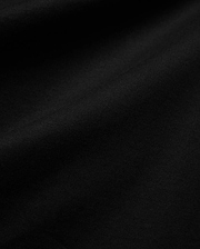 Mens Isaac Relaxed Fit Tee, a premium Psycho Bunny black jersey knit fabric, showcasing its soft, smooth texture with subtle, elegant folds, ideal for refined streetwear.