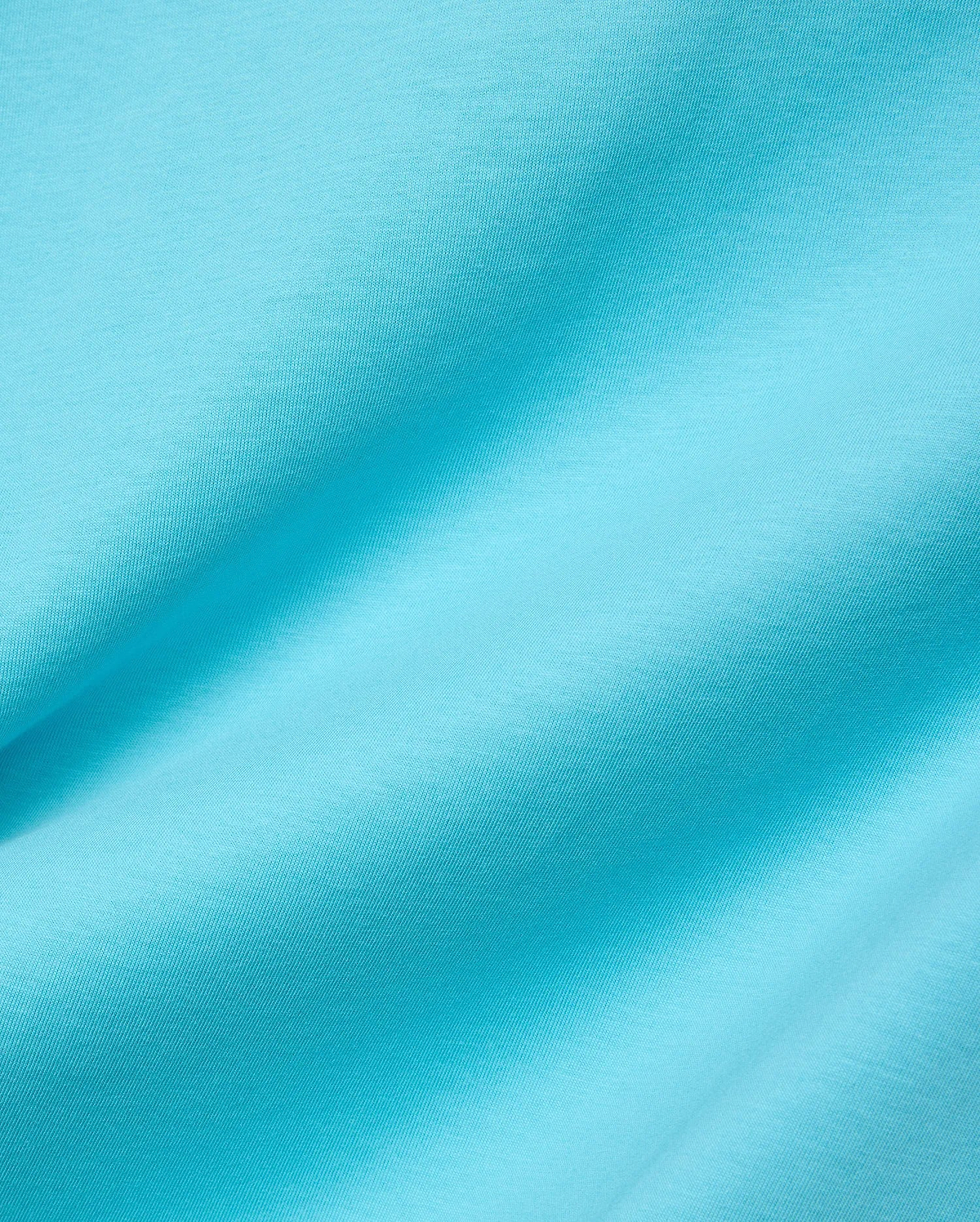 Mens Isaac Relaxed Fit Tee in bright aqua blue, soft jersey knit fabric with visible subtle texture and gentle folds, featuring the iconic small embroidered Psycho Bunny skull logo on the chest.