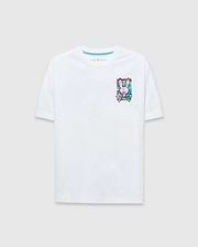 Mens Isaac Relaxed Fit Tee, a white jersey t-shirt with a relaxed fit, featuring a vibrant multi-color graphic Psycho Bunny skull logo on the left chest and a blue inner neck stripe.