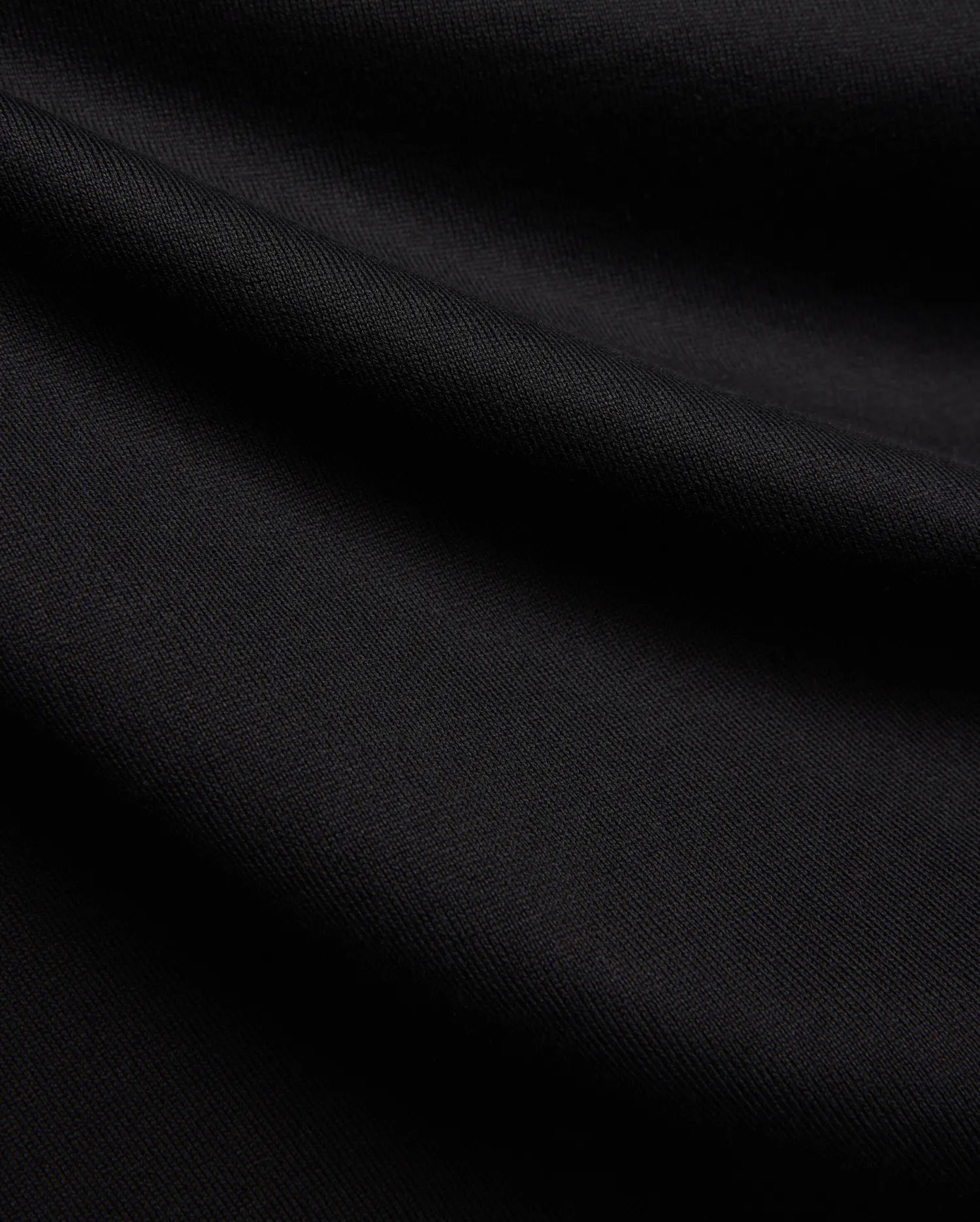 Black MENS DUNCAN RELAXED FIT TEE, a soft, premium jersey knit fabric with subtle folds, emphasizing its comfortable relaxed fit.