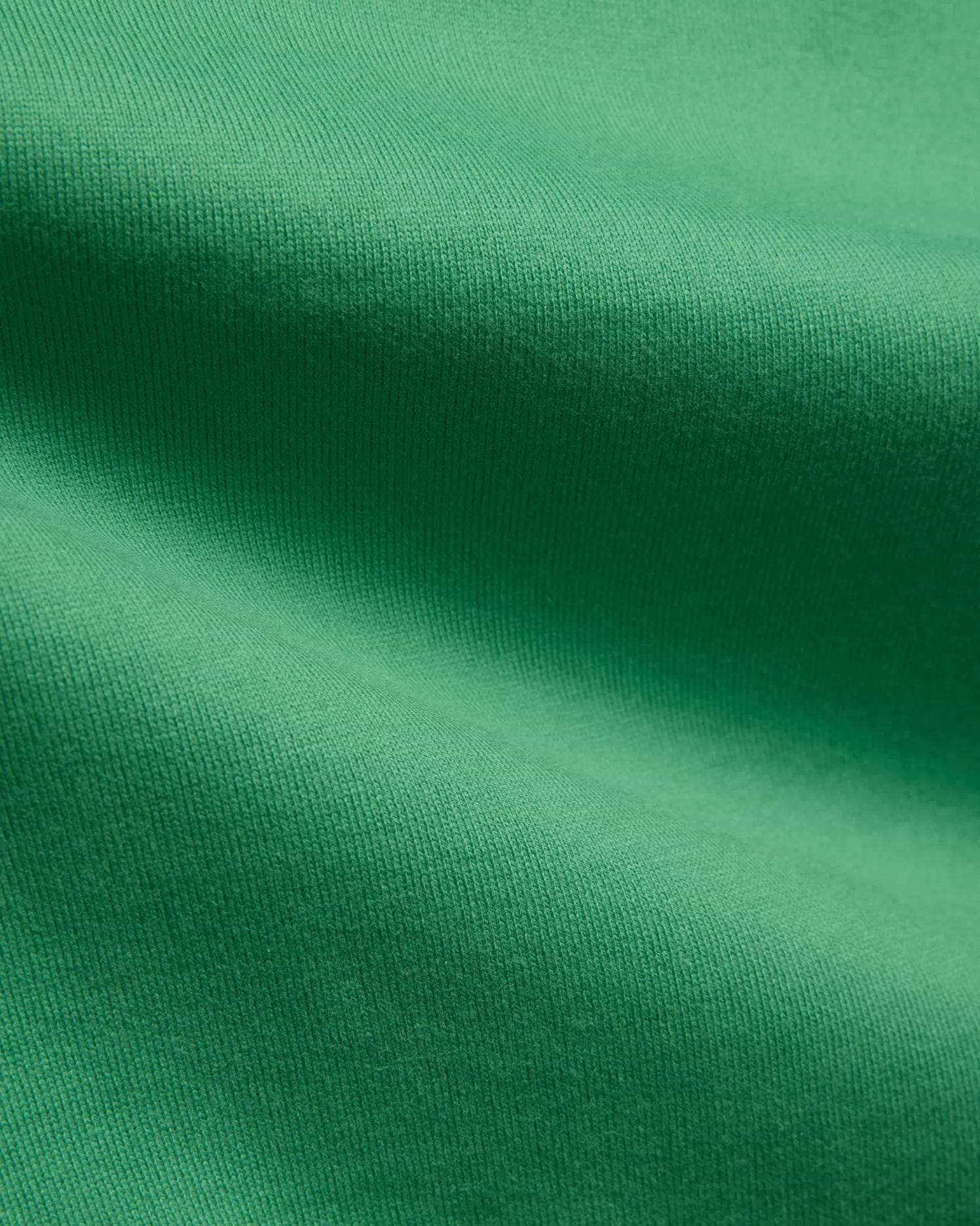 Mens Duncan Relaxed Fit Tee in vibrant emerald green, featuring a soft, premium jersey knit fabric with subtle vertical ribbing, emphasizing its comfortable, relaxed fit.