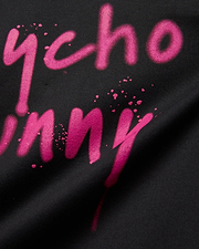 Mens Duncan Wordmark Relaxed Fit Tee, black with a vibrant pink spray paint style Psycho Bunny wordmark graphic featuring paint splatters and a soft jersey texture.