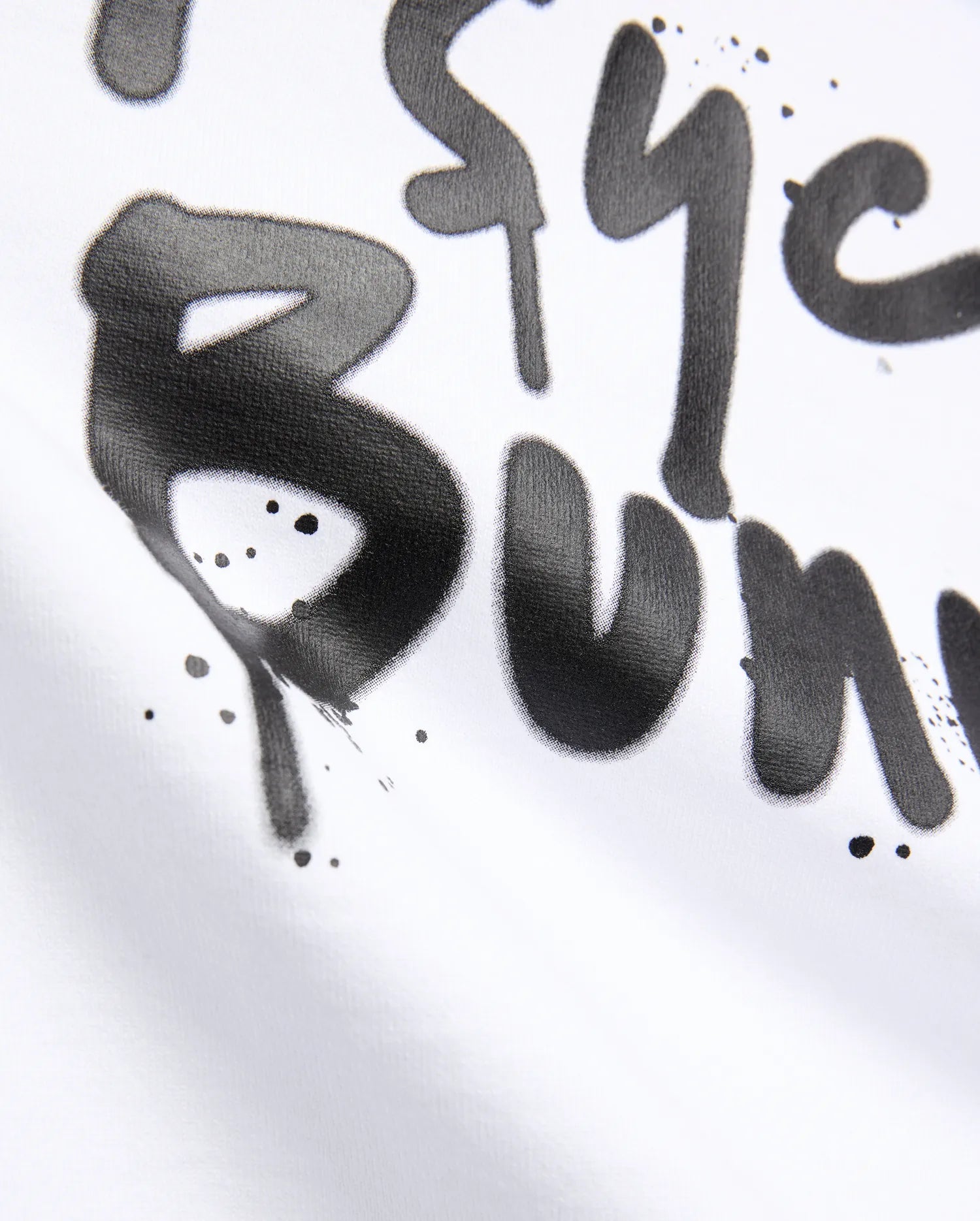 White Mens Duncan Wordmark Relaxed Fit Tee featuring a large, central black graffiti-style Psycho Bunny wordmark print with subtle paint splatters on smooth jersey fabric.