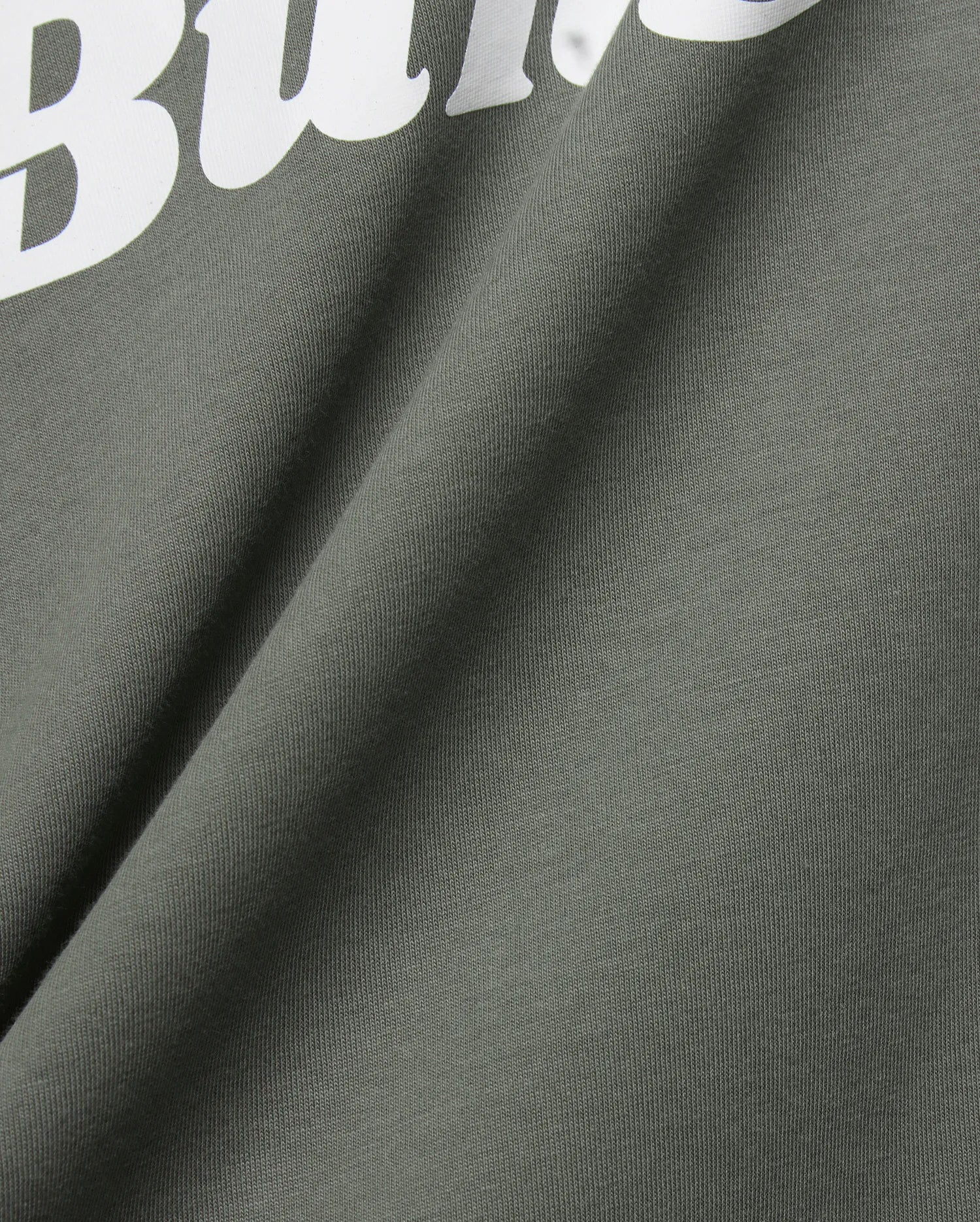 Mens Byron Wordmark Tee in dark olive green, crafted from soft jersey knit fabric. Features a prominent, large white wordmark graphic, with the letters Bu clearly visible, embodying the iconic Psycho Bunny brand.